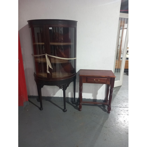 138 - A bowed glass fronted mahogany display cabinet together with a hall table