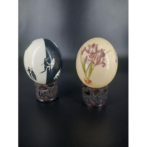 202 - Two hand painted Ostrich eggs on stands