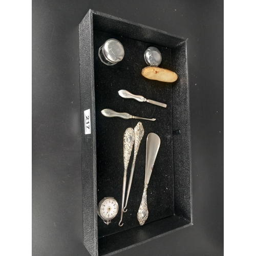 217 - A silver ladies pocket watch, silver handled shoe horn and button hooks, silver handles manicure set... 