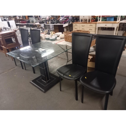 395 - A glass topped dining table and four chairs