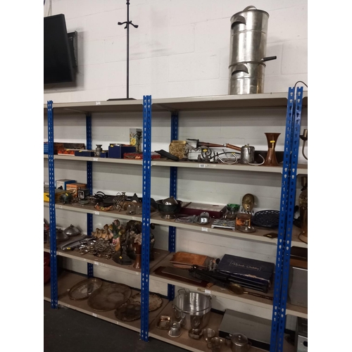 428 - 10 shelves of metalware to include door stop, companion sets, cutlery etc