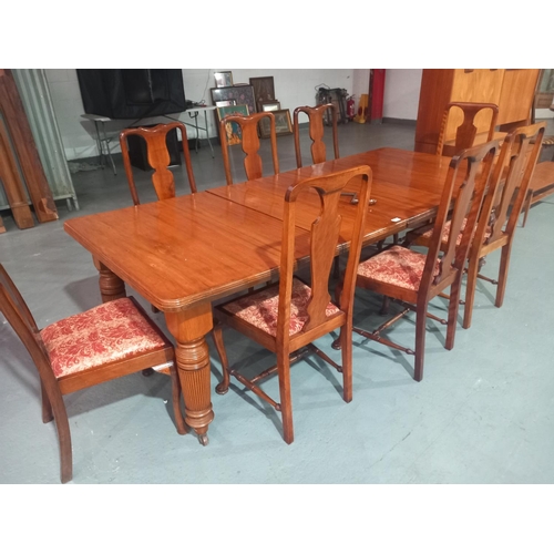 119 - A mahogany wind out dining table with two extra leaves and hand crank together with eight chairs