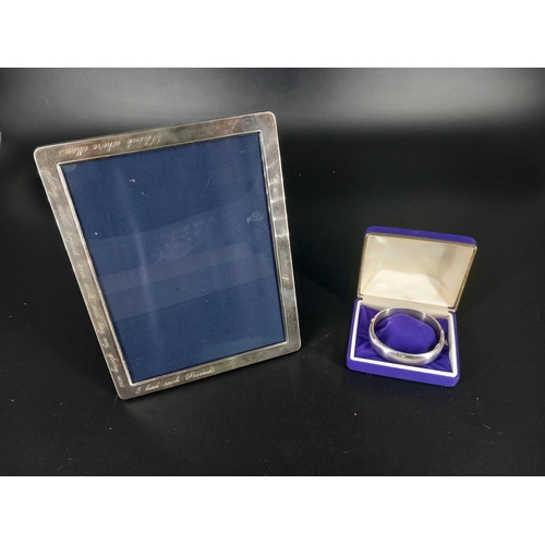 212 - A hallmarked silver photo frame 9 x 7 inches together with a silver bangle