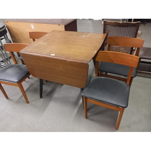 402 - A mid century drop leaf dining table together with four teak dining chairs