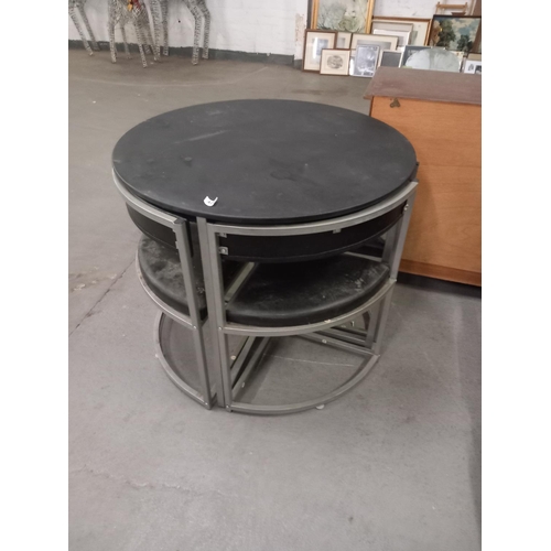 403 - A space saving circular dining table with four chairs