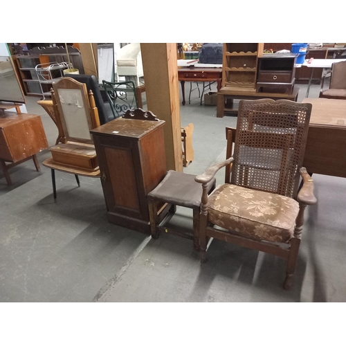 413 - A ratten backed armchair, leatherette stool, pot cupboard and dressing table mirror