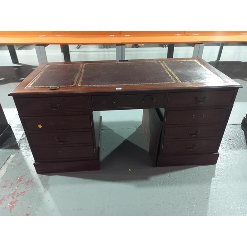 559 - A twin pedestal desk with leatherette insert