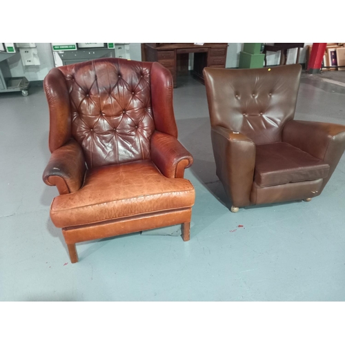 562 - A tan leather armchair together with a mid century style armchair