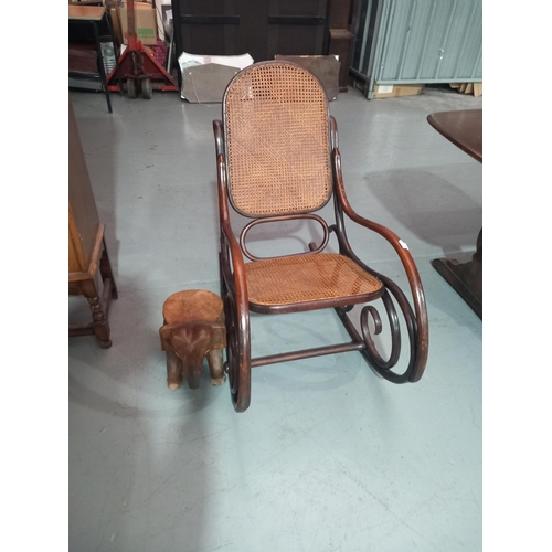 566 - A Thonet rocking chair and an African elephant stool