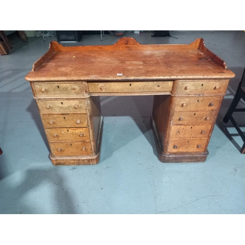 570 - An oak twin pedestal desk with gallery