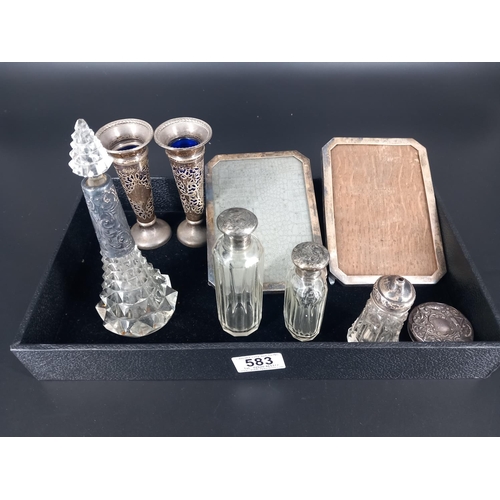 583 - Silver picture frames,silver topped dressing table bottles, a pair of silver bud vases etc