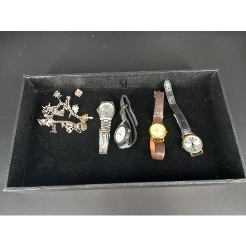 575 - A silver charm bracelet with fifteen charms and four gents watches to include Seiko