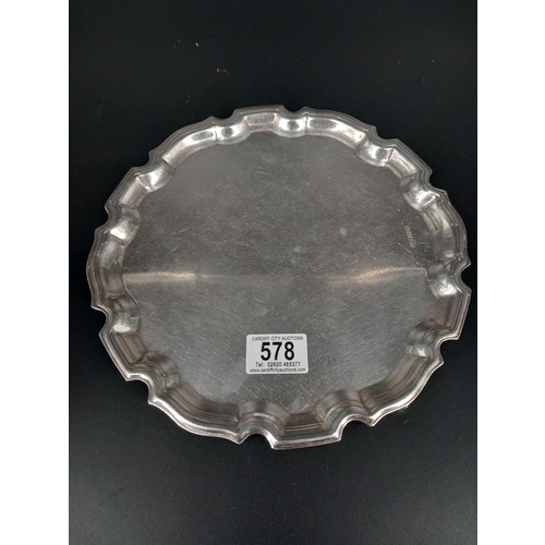 578 - A hallmarked silver circular scroll border, footed serving tray - hallmarks for Sheffield - Elkingto... 