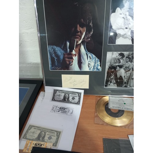 14 - A good collection of Elvis memorablia - a framed tour poster print, a framed collection of elvis pho... 