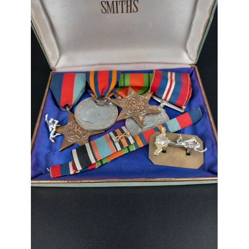 133 - A group of WW2 medals - 39-45 and burma stars, war and defence medals, ribbon bar for royal signals,... 