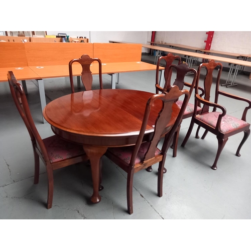 72 - An extending mahogany oval dining table together with six chairs to include two carvers