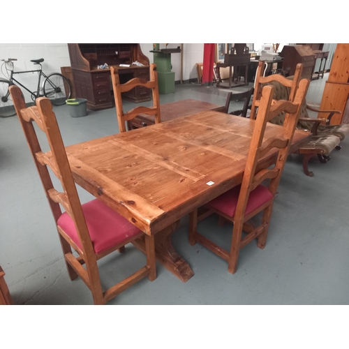 118 - A pine dining table together with four chairs