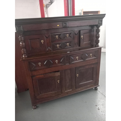 128 - An 18th century and later cardiganshire oak deaddam havng an arrangement of geometric drawers and bl... 