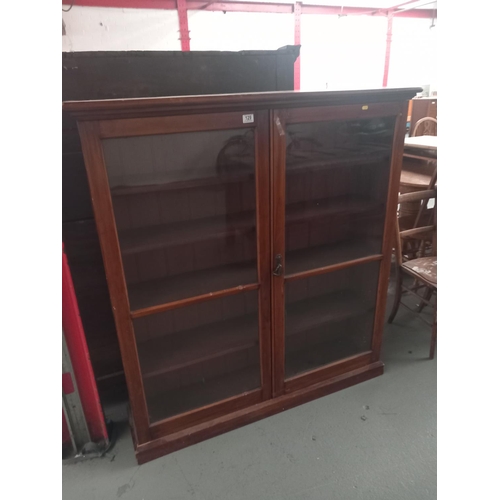 129 - A mahogany double door glazed bookcase