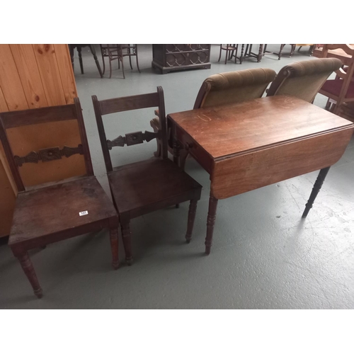 137 - A pembroke drop leaf dining table together with two dining chairs