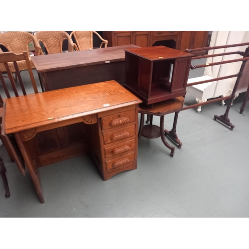 119 - A small oak desk, swivel bookcase, clothes rail and a side table