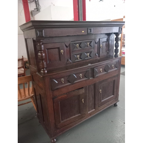 125 - An 18th century and later cardiganshire oak deaddam havng an arrangement of geometric drawers and bl... 