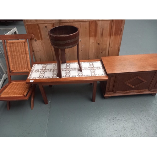 135 - An oak blanket box, plant stand, tiled top coffee table and a folding chair