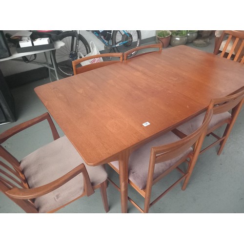 141 - A teak extending dining table and six chairs (possibly Mcintosh)