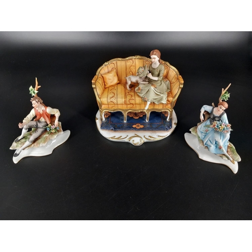 200 - Three signed Capodimonte figures - girls on a bench with a dog and a seated male and female figure