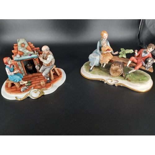 202 - Two large Capodimonte figures - a family on a seasaw and a living room scene