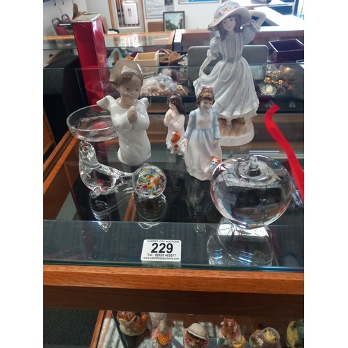 229 - Royal Doulton figurines, a Lladro angel and glass paperweights