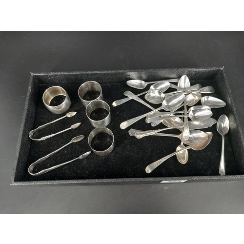 224 - A collection of hallmarked silver napkin rings, silver teaspoons and sugar tongs total silver weight... 