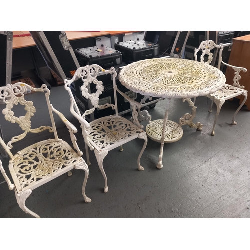 108 - A cast iron garden table and three chairs