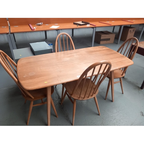 110 - An ercol dining table and four chairs