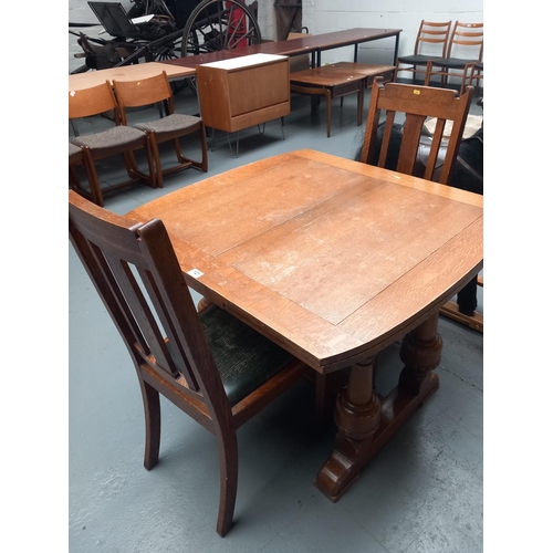 121 - An oak draw leaf extending dining table and two chairs