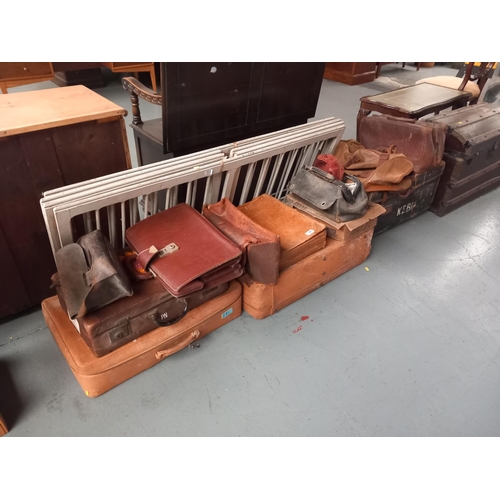 124 - A selection of trunks, leatherette suitcases, gladstone style bags etc