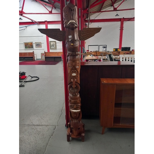 135 - A carved bone inlaid totem pole