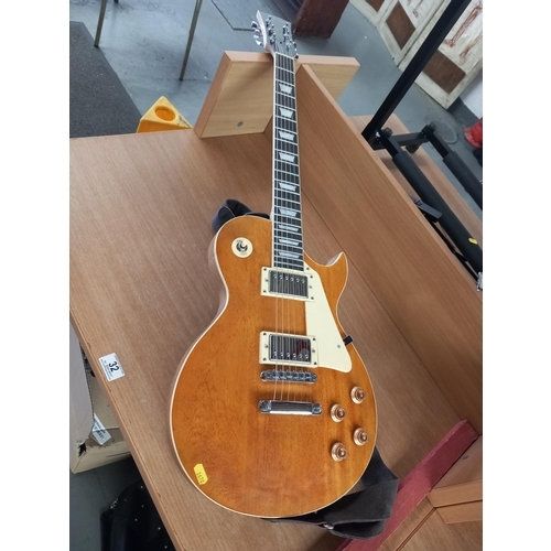 32 - An electric gibson les paul custom guitar -believed to be a copy