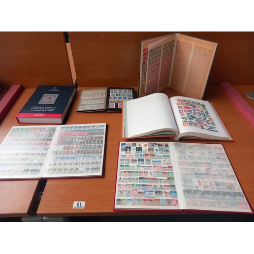 61 - 5 stamp albums containing world stamps and a stanley gibbons catalogue