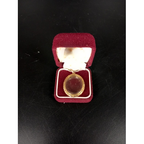 210 - A 9k gold large locket with double sided glass panels - weight including glass 7.1grams