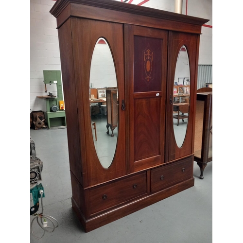 116 - A mahogany inlaid three section wardrobe