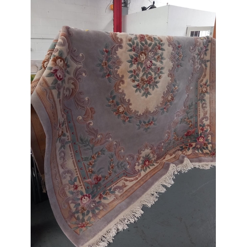 122 - A large Chinese wool rug. The condition is generally good, with the odd mark. Size is 123 inches x 9... 