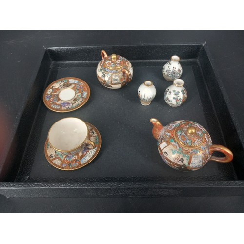 209 - An early Japanese satsuma (hand painted) part minature tea set consisting of a cup and saucer, a sau... 