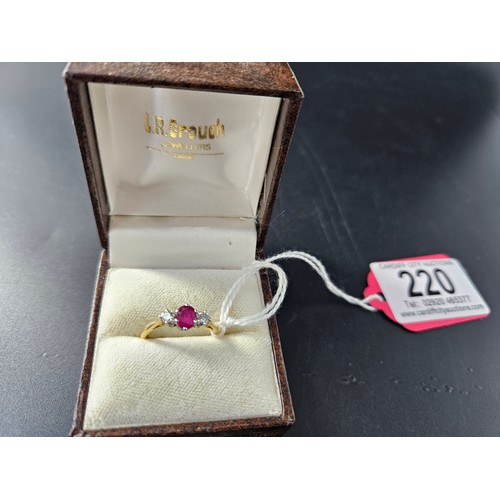 220 - An 18k gold diamond and ruby three stone ladies ring - weight including ruby and diamonds is 2.4 gra... 