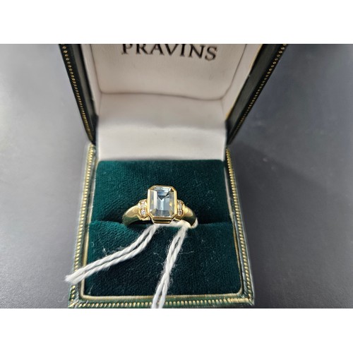 222 - An 18k gold and aquamarine single stone ladies dress ring - weight including stone is 4.8 grams