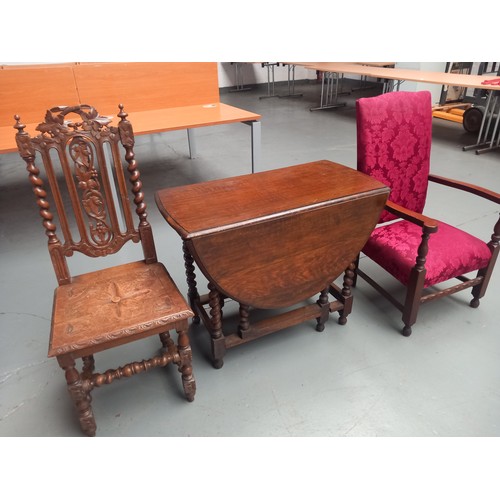 114 - An oak drop leaf dining table on barley twist supports, hall chair and upholstered armchair