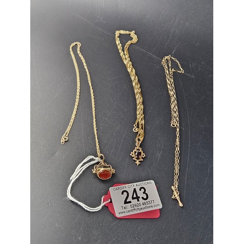 243 - A 9k gold stone watch fob on 9k gold chain, a 9k gold chain and a 9k gold pendant with garnet on 9k ... 