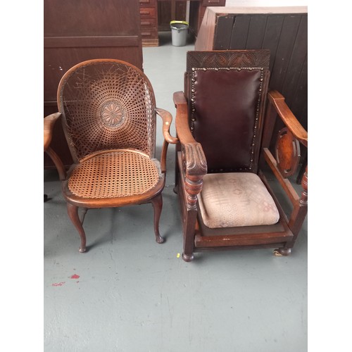 139 - An oak steamer chair together with a cane seated armchair with damage to cane