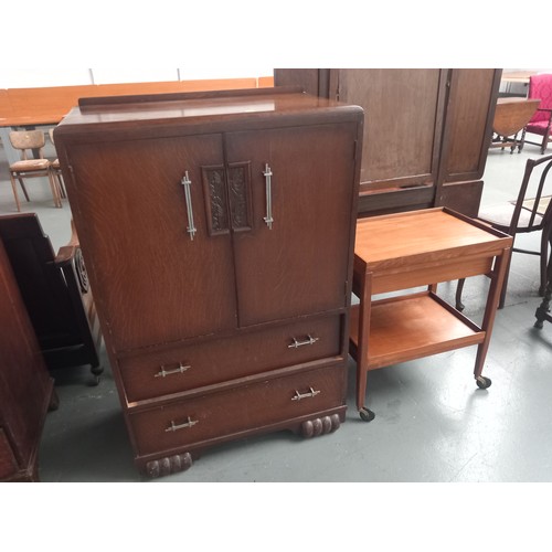 146 - An oak tallboy together with a teak drinks trolley

Height 126cm
Width 82cm
Depth 44cm