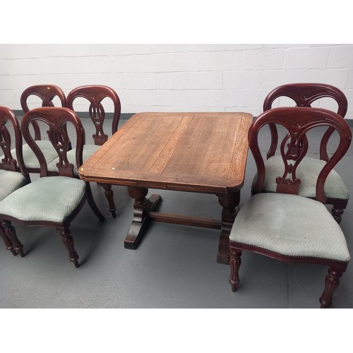 165 - An oak draw leaf dining table together with six mahogany framed chairs